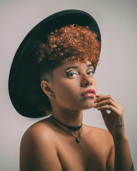 an image of woman with crazy hair wearing big hat