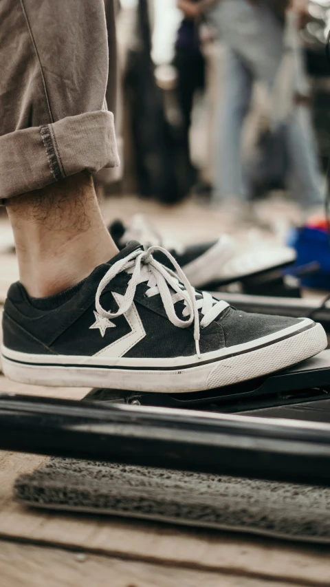 a man's legs in white and black shoes