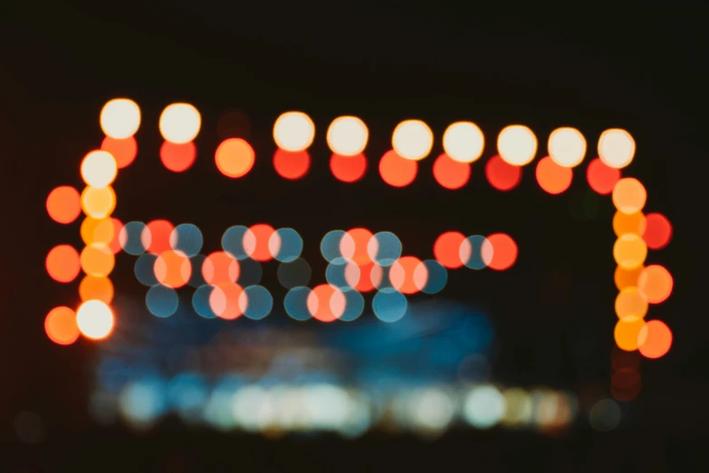 an abstract blurry image with a gate covered in lights