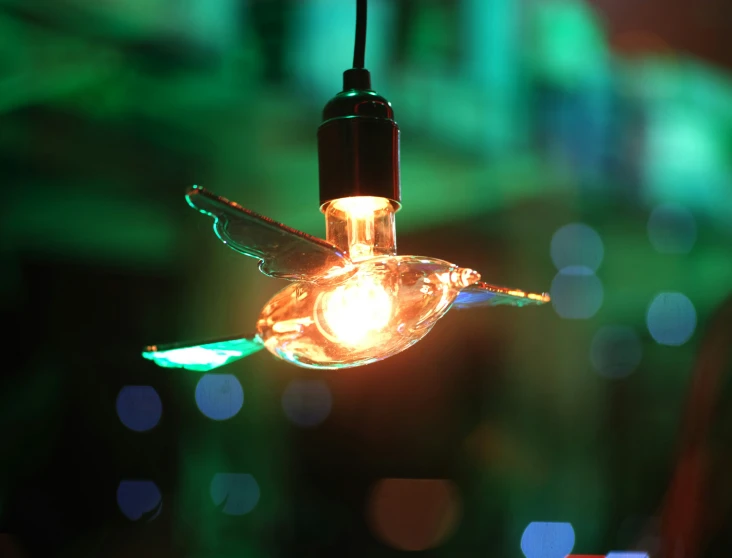 a humming bird ornament with lights on