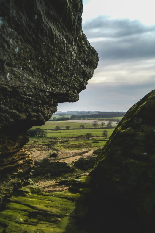 an open cave on the edge of a mountain