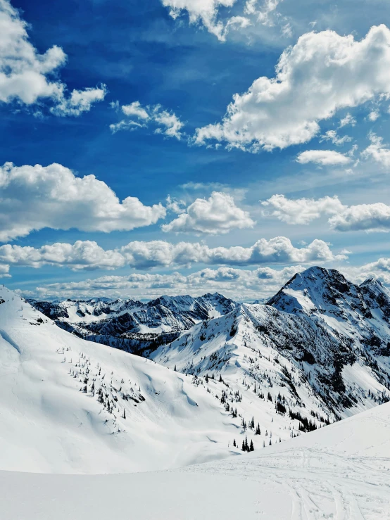 a picture of some hills with clouds in the sky