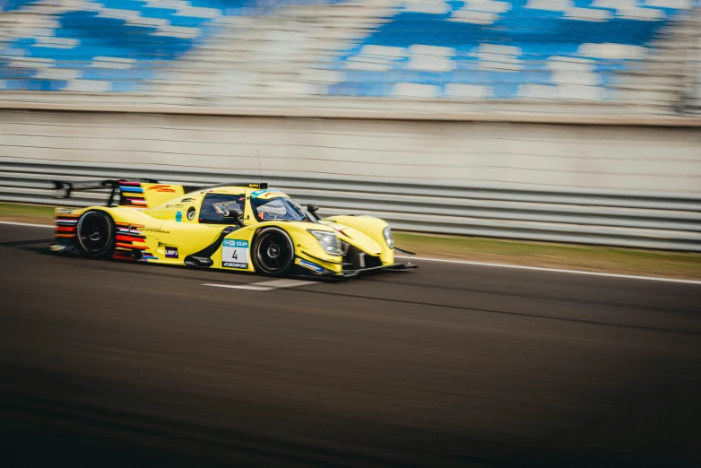 a yellow race car on the road