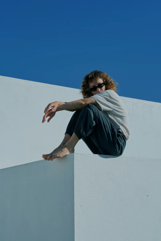 the skateboarder is doing a stunt on a building