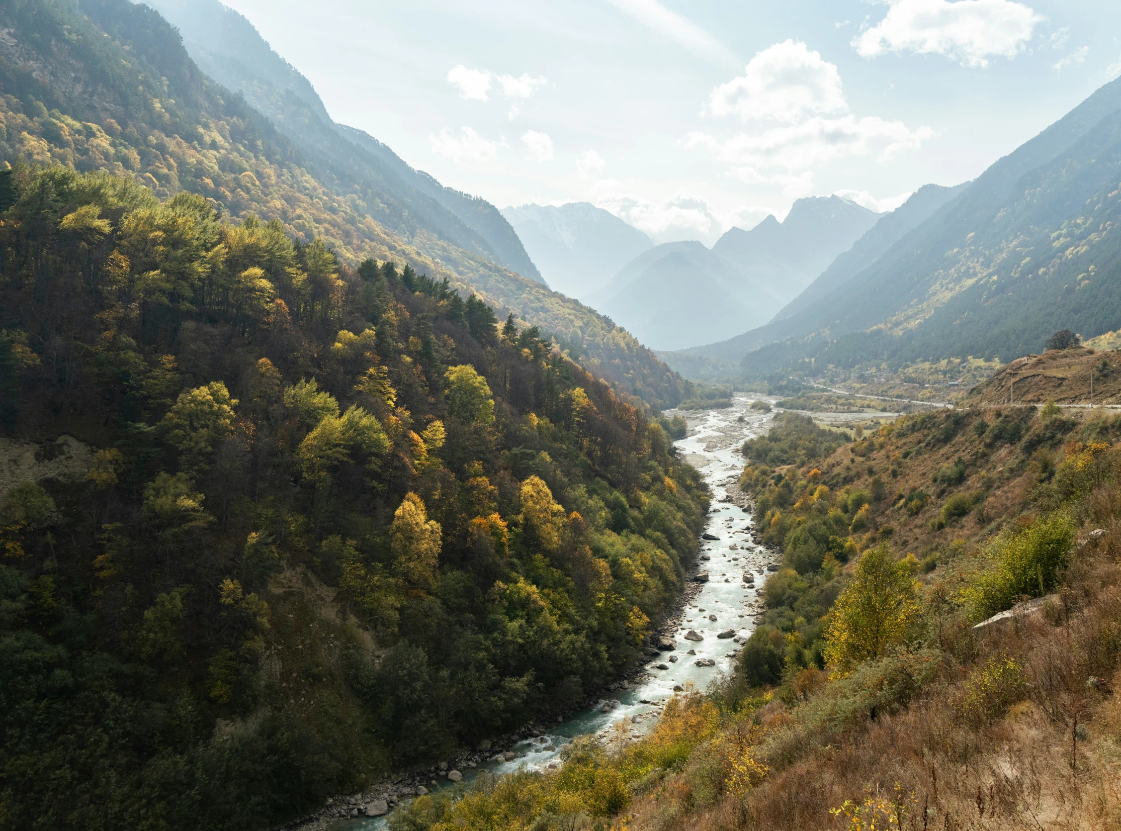 this picture shows a mountainous river running through the countryside