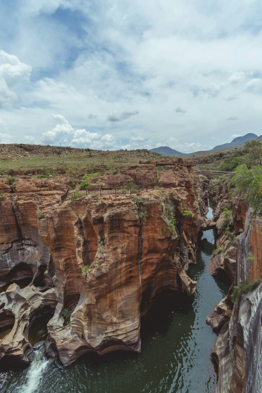 a canyon has a small waterfall in the middle of it