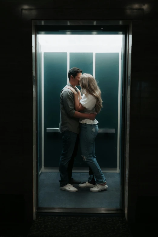 man and woman in front of an open elevator