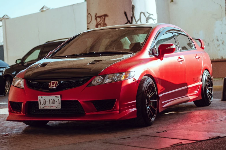 a red car is parked in a parking lot