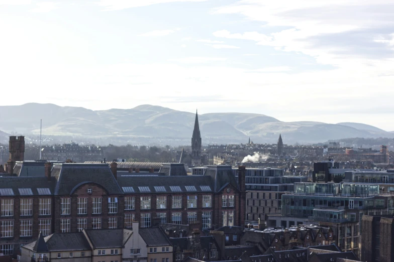 there is a very tall building and a lot of mountains in the background