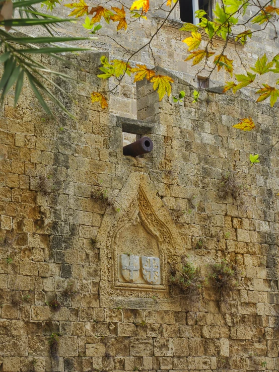 a clock on the side of a stone building with a window