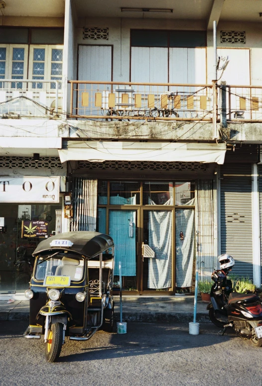 a car parked outside of a building and a bicycle