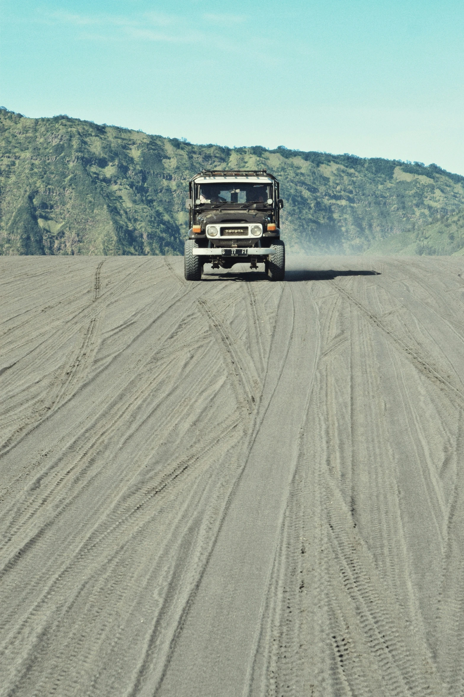 a truck driving in a vast vast open field