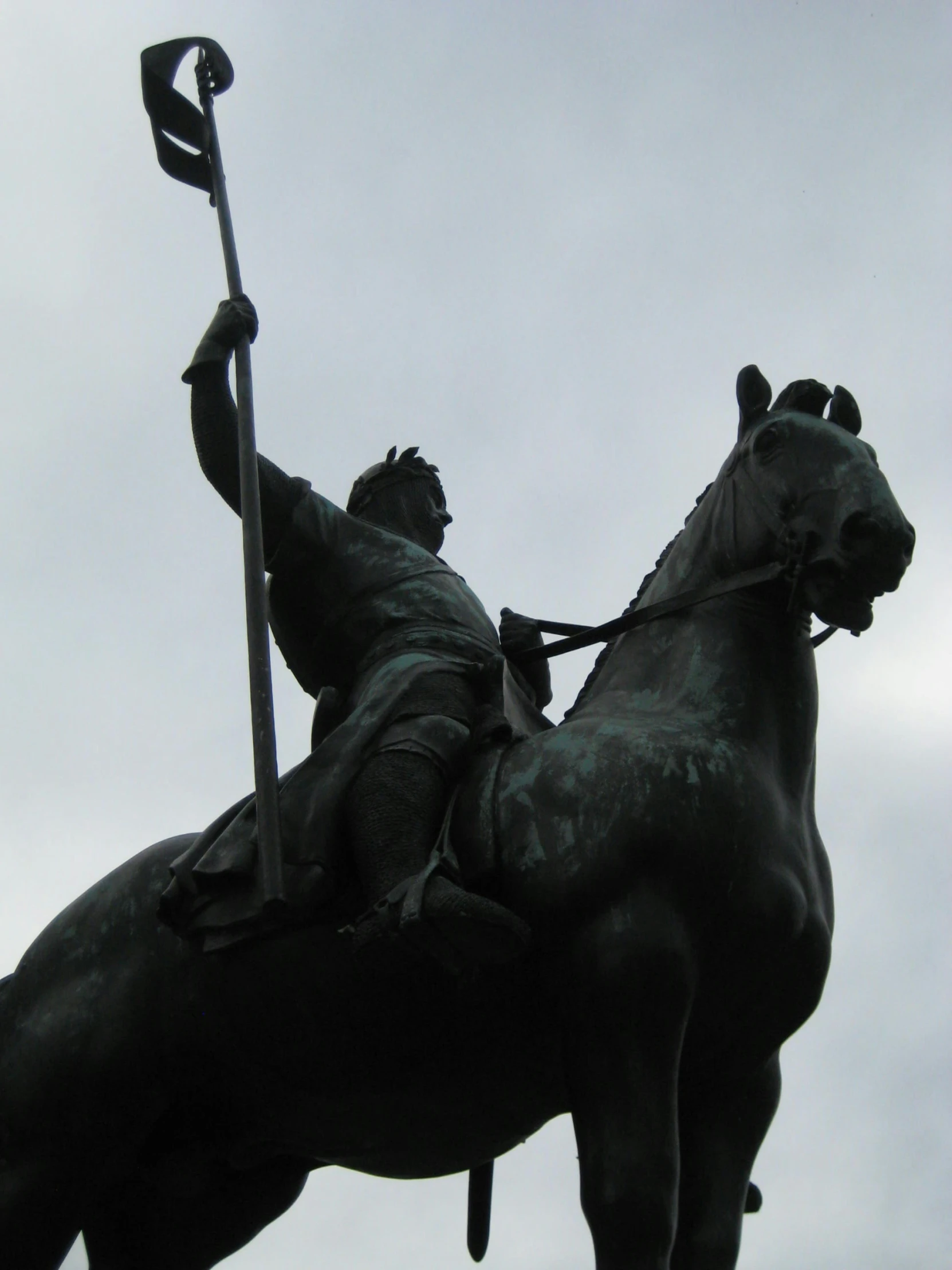 a statue of a man on a horse that is holding a spear