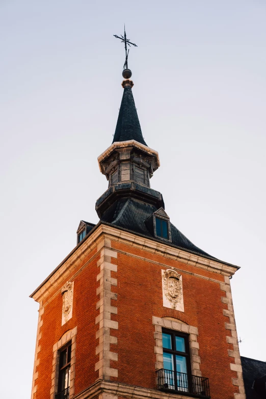 a brick building with a clock and a steeple