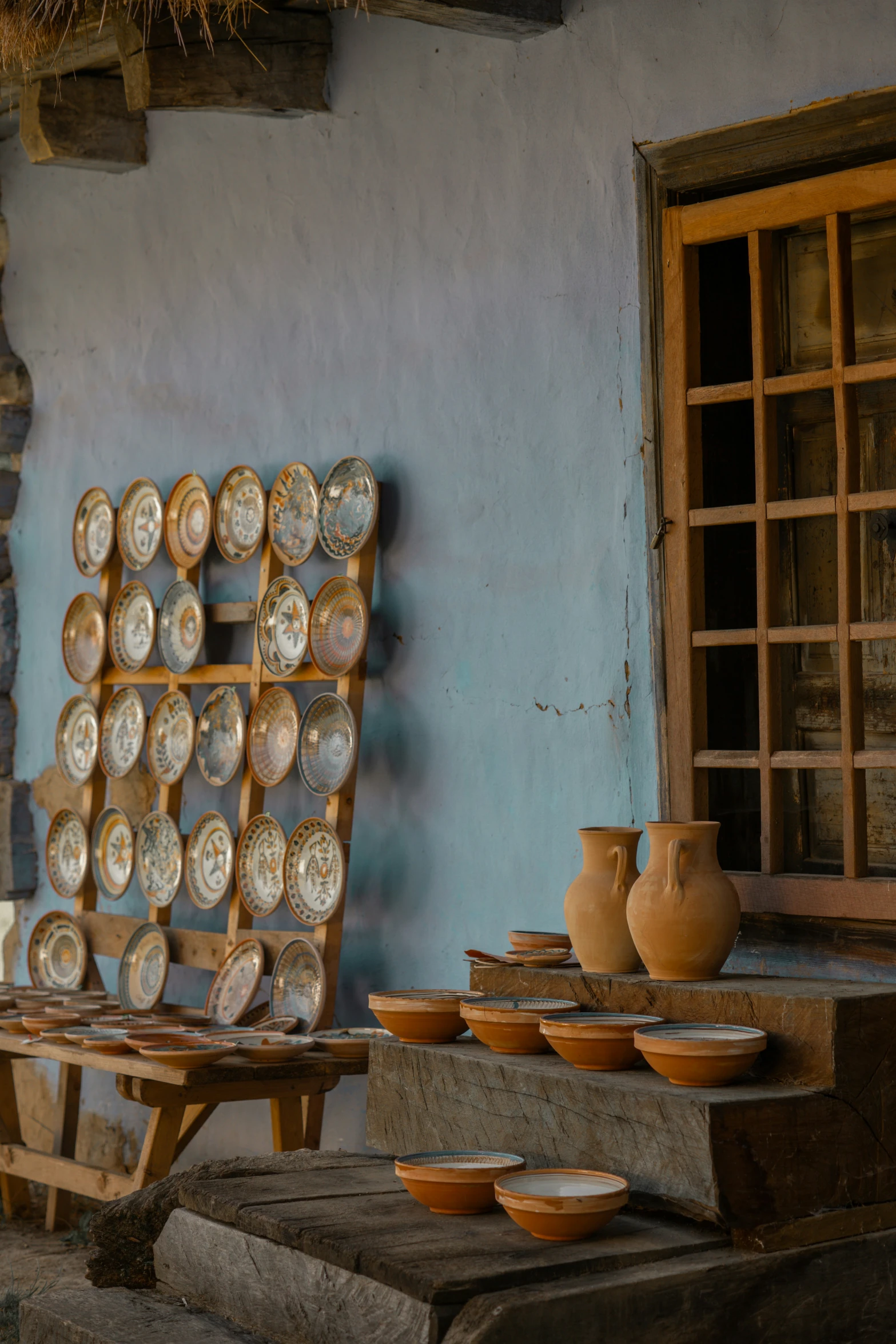 the pots are being displayed by the pottery workshop