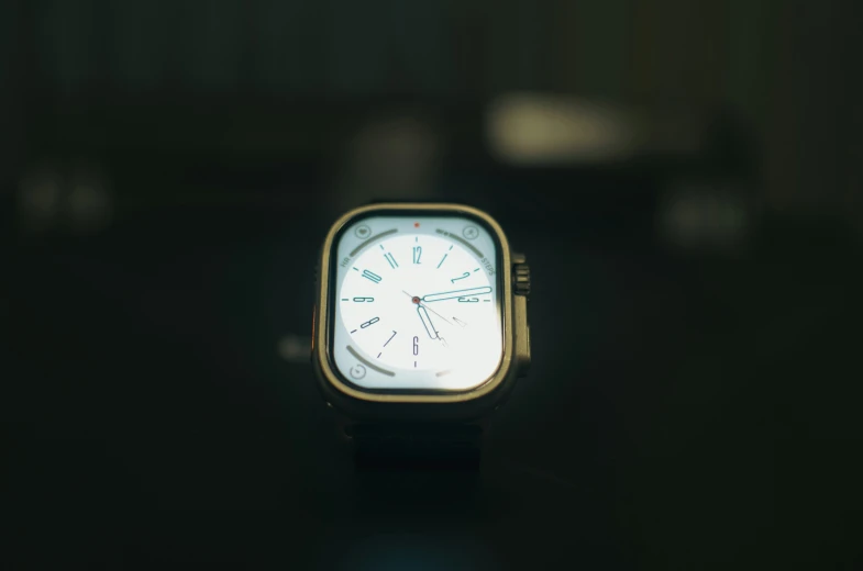 an square watch is shown on the table