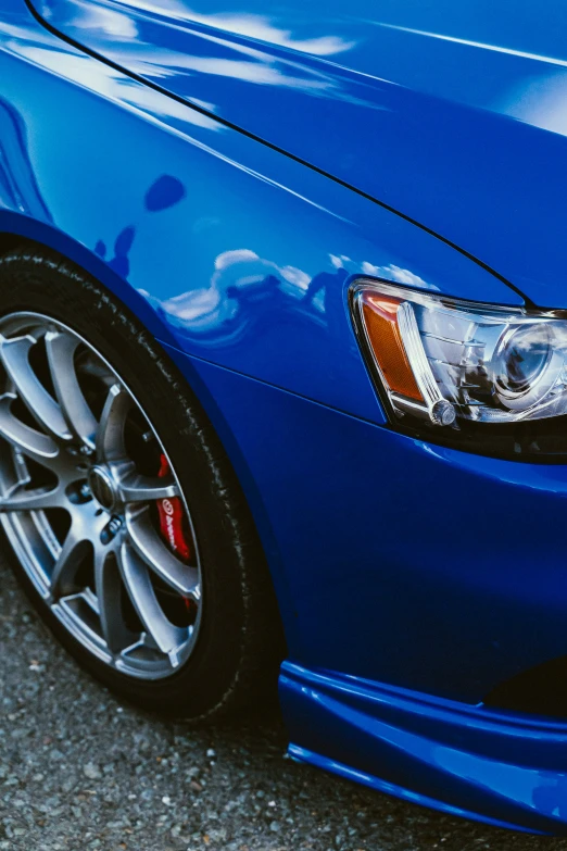 close up po of front bumper and ke lights on a blue car