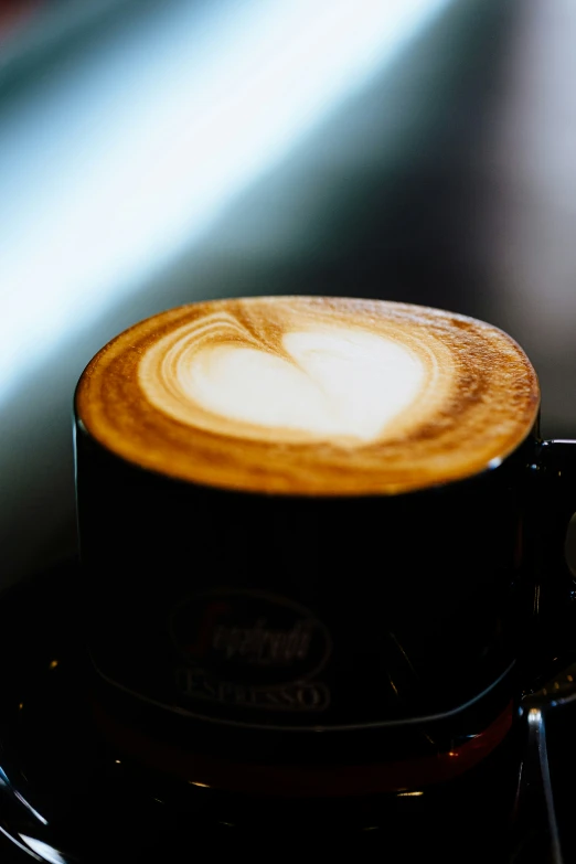 a coffee latte is sitting on a coffee machine