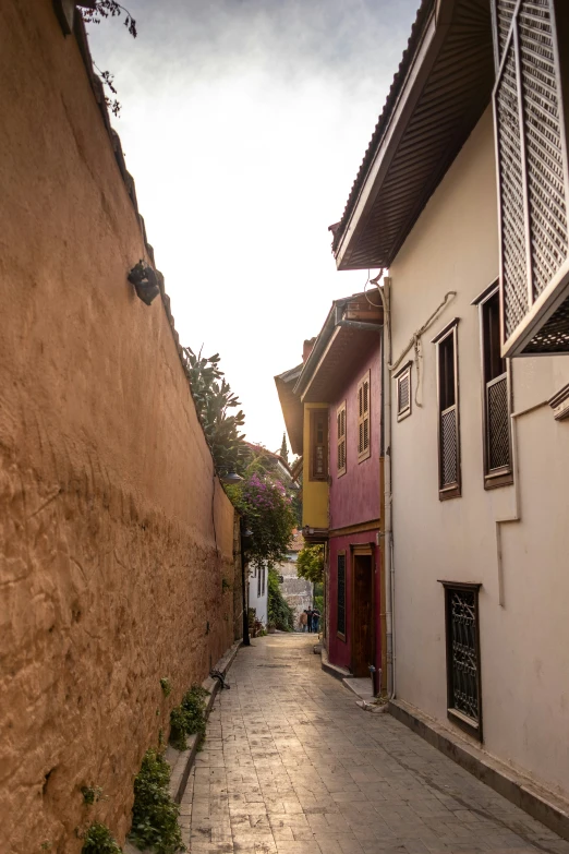 there is an empty narrow alley in the city