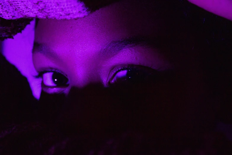 a girl with purple light in her eyes