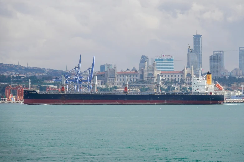 a ship traveling in the ocean on a partly cloudy day