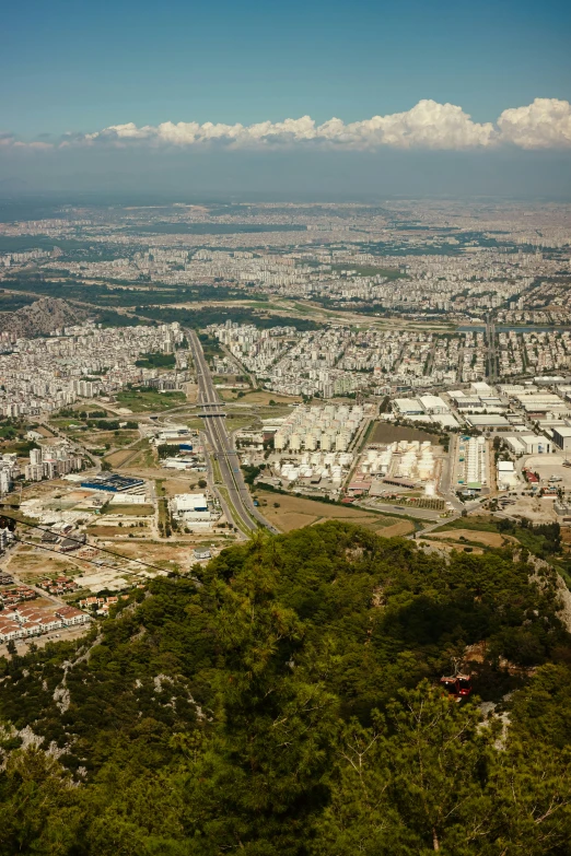 an aerial view of a city with cars driving along it