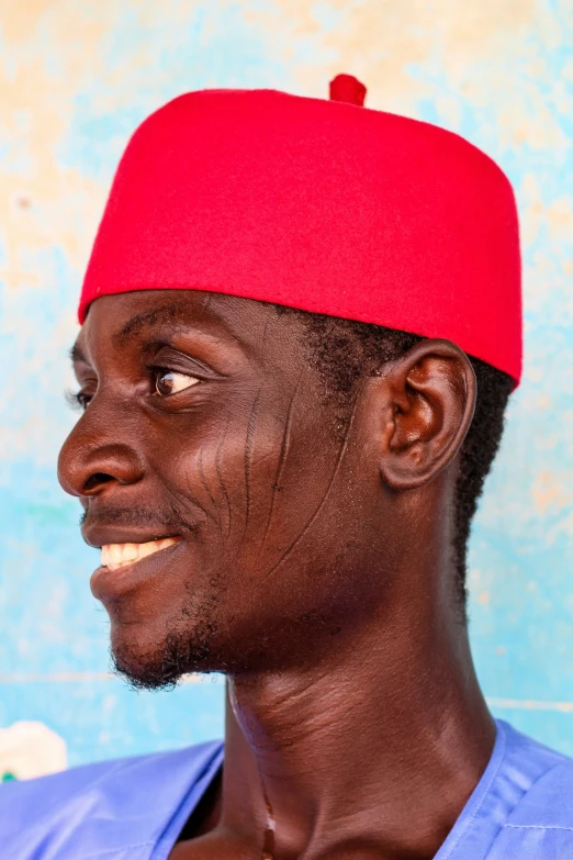 a man with a red hat is smiling