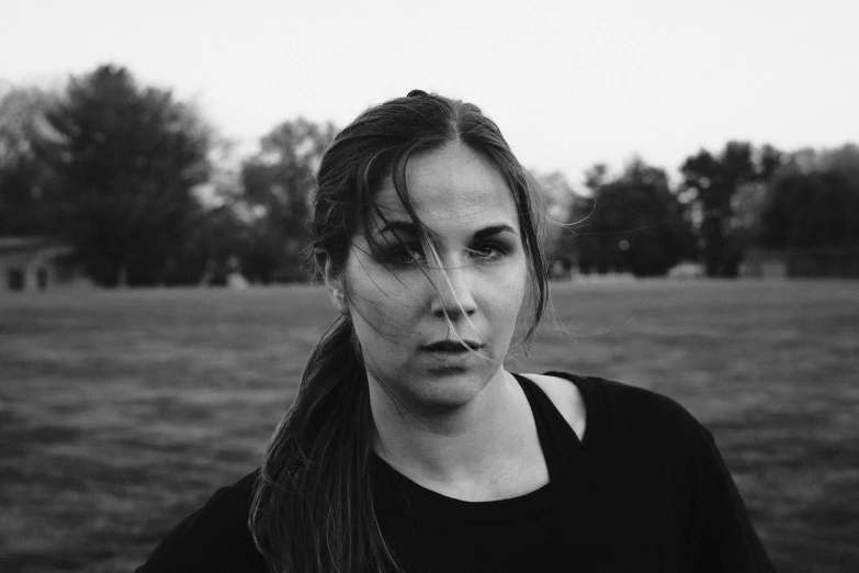 a close up of a person in front of a field