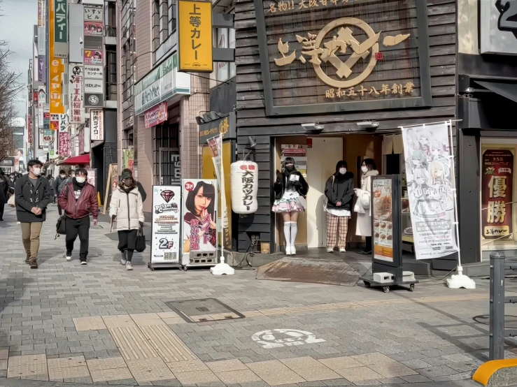 a street view with people walking past stores