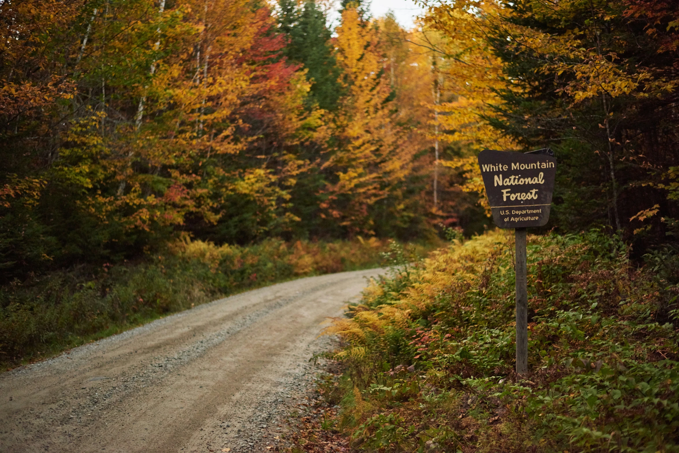 a sign that is on a dirt road