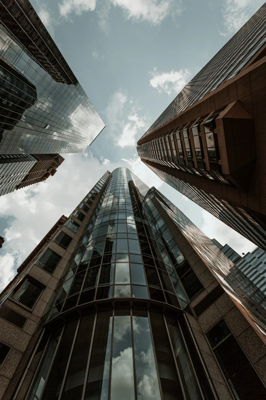 the view looking up at tall buildings in a city