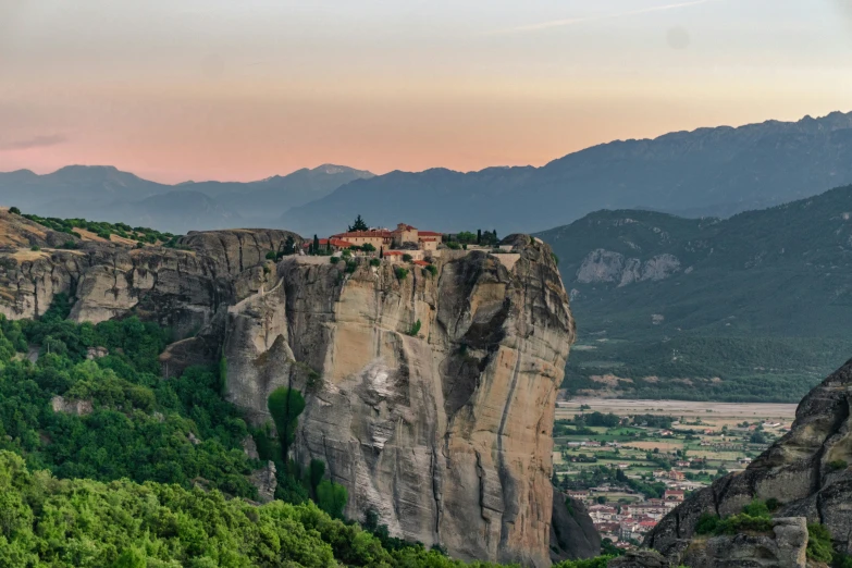 a small hill town is set atop a mountain in italy