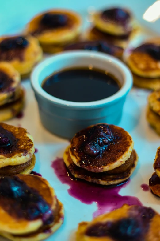 several pancakes with jam are arranged on a plate