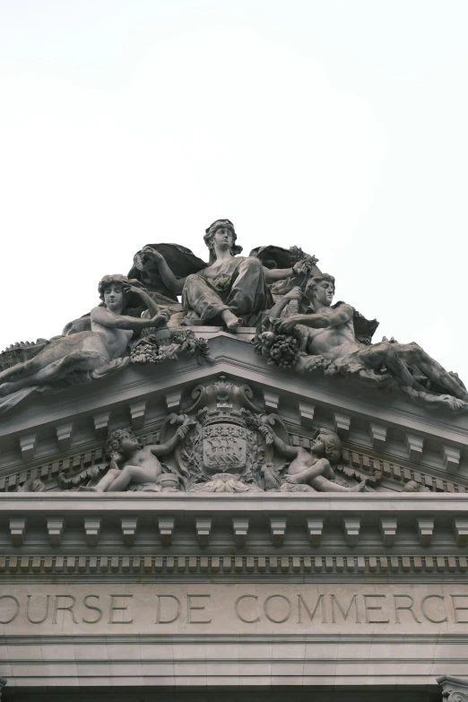 an ornate roof with a statue of a woman on top