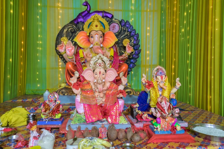 a ganpati on stage surrounded by other decorative objects