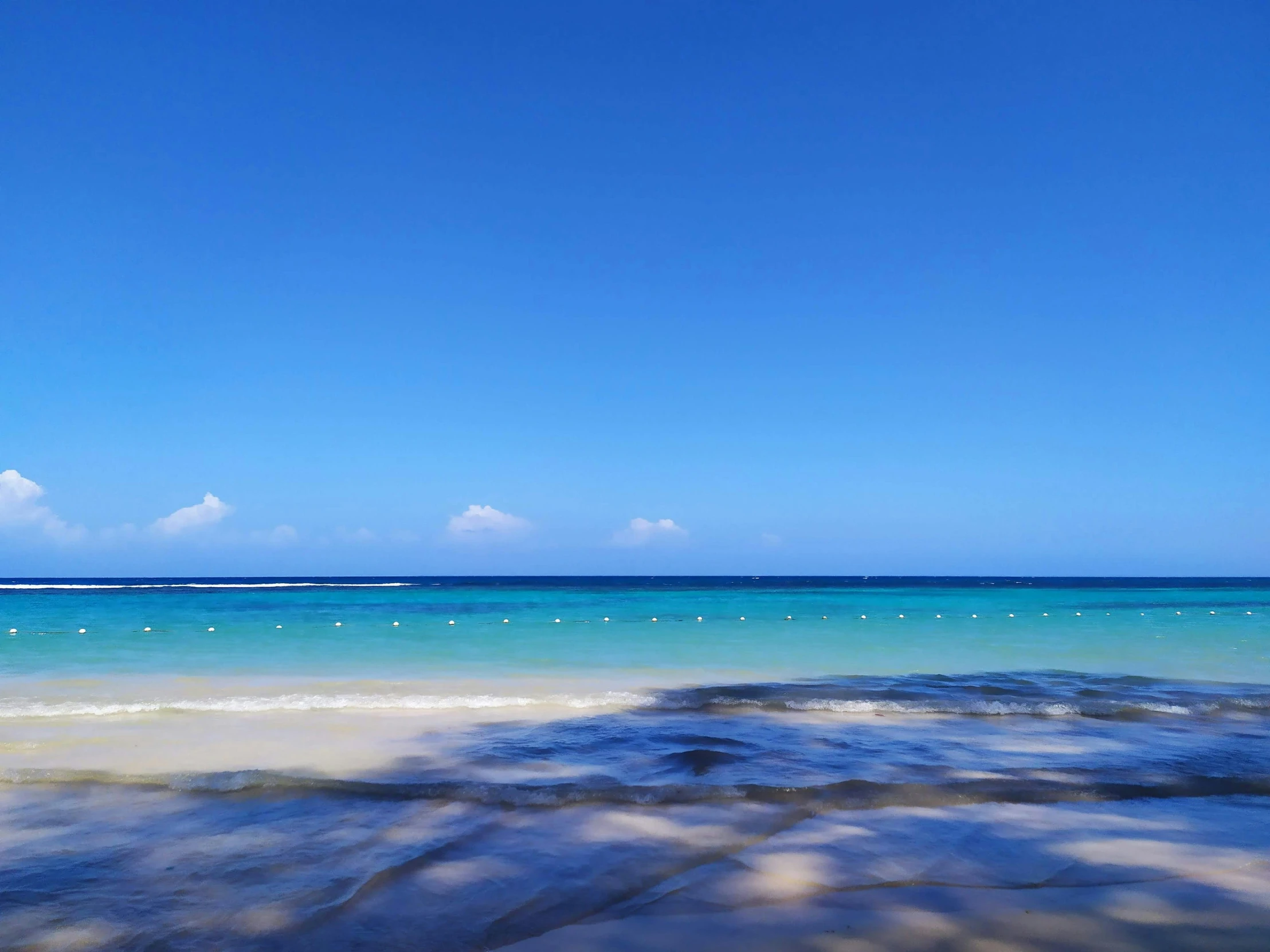 the sky over a beach filled with water