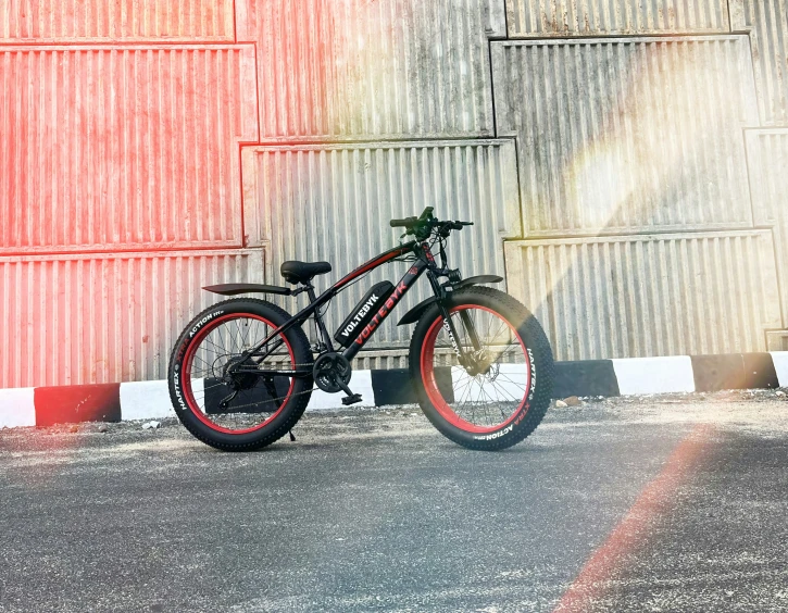 the bicycle is parked in front of the wall