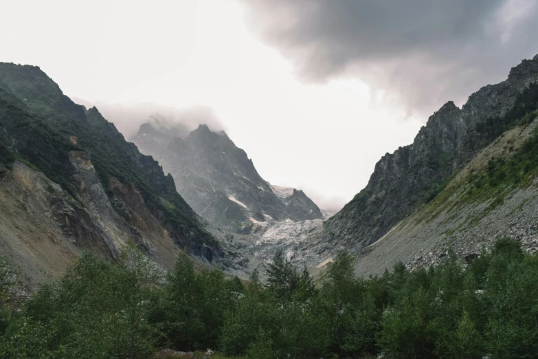 an overcast sky above a valley of mountains