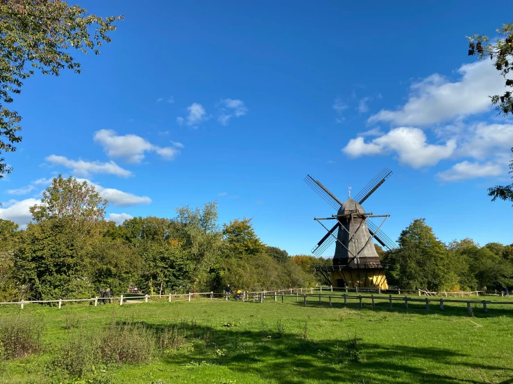 a large old windmill is seen on a clear day