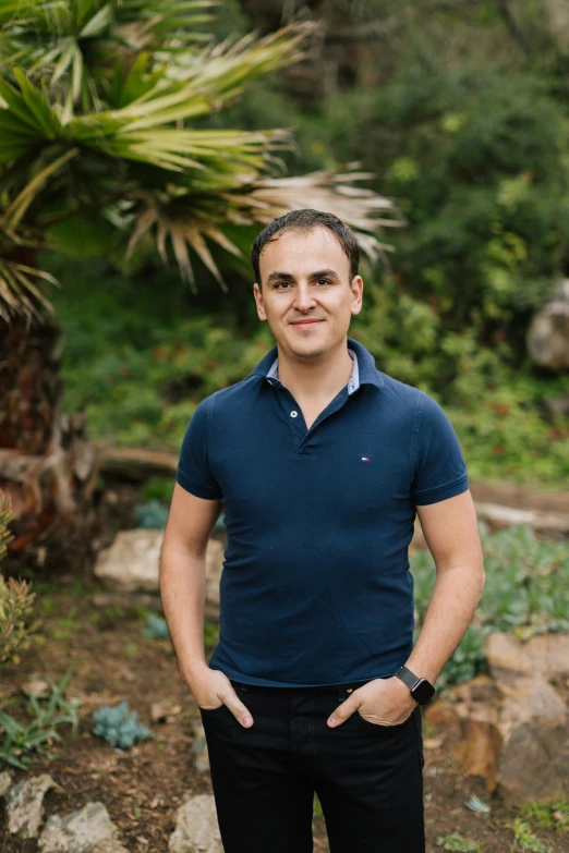 a man in a blue shirt and black pants