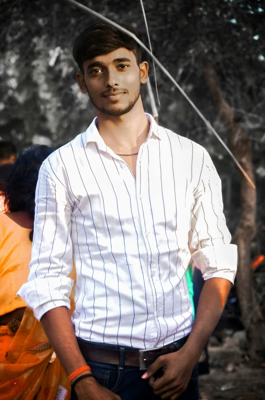 a young man poses for a po wearing an umbrella