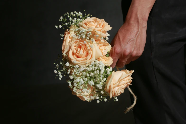 a brides bouquet being held by her groom