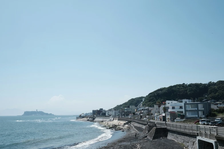 houses overlooking an ocean and a hill side