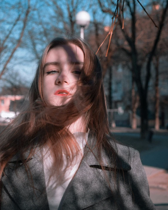 woman with long hair looking at her phone