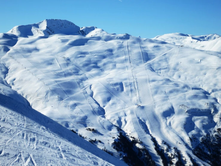 there are skiers standing on the side of a mountain