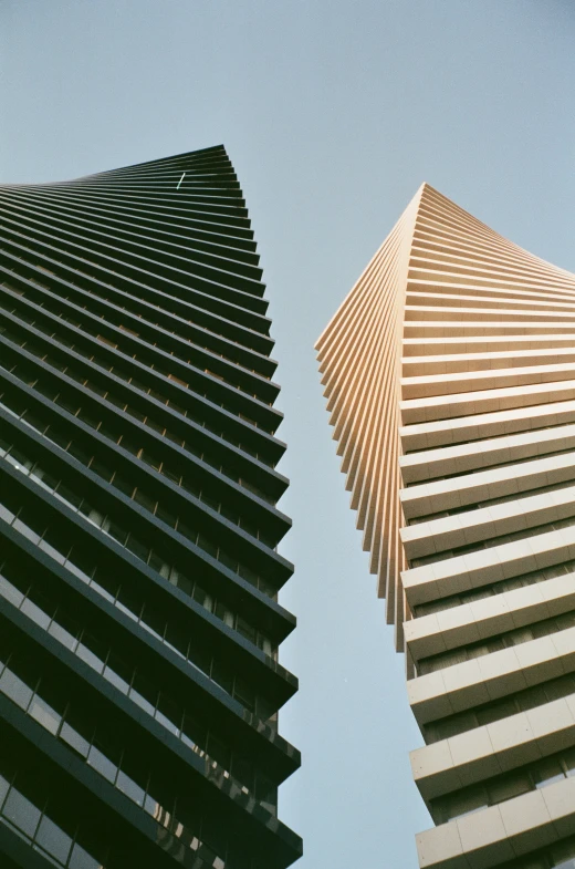 an upward view of some building next to each other