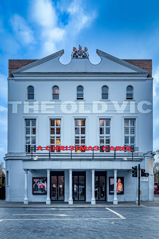 the front of a large white building on a street