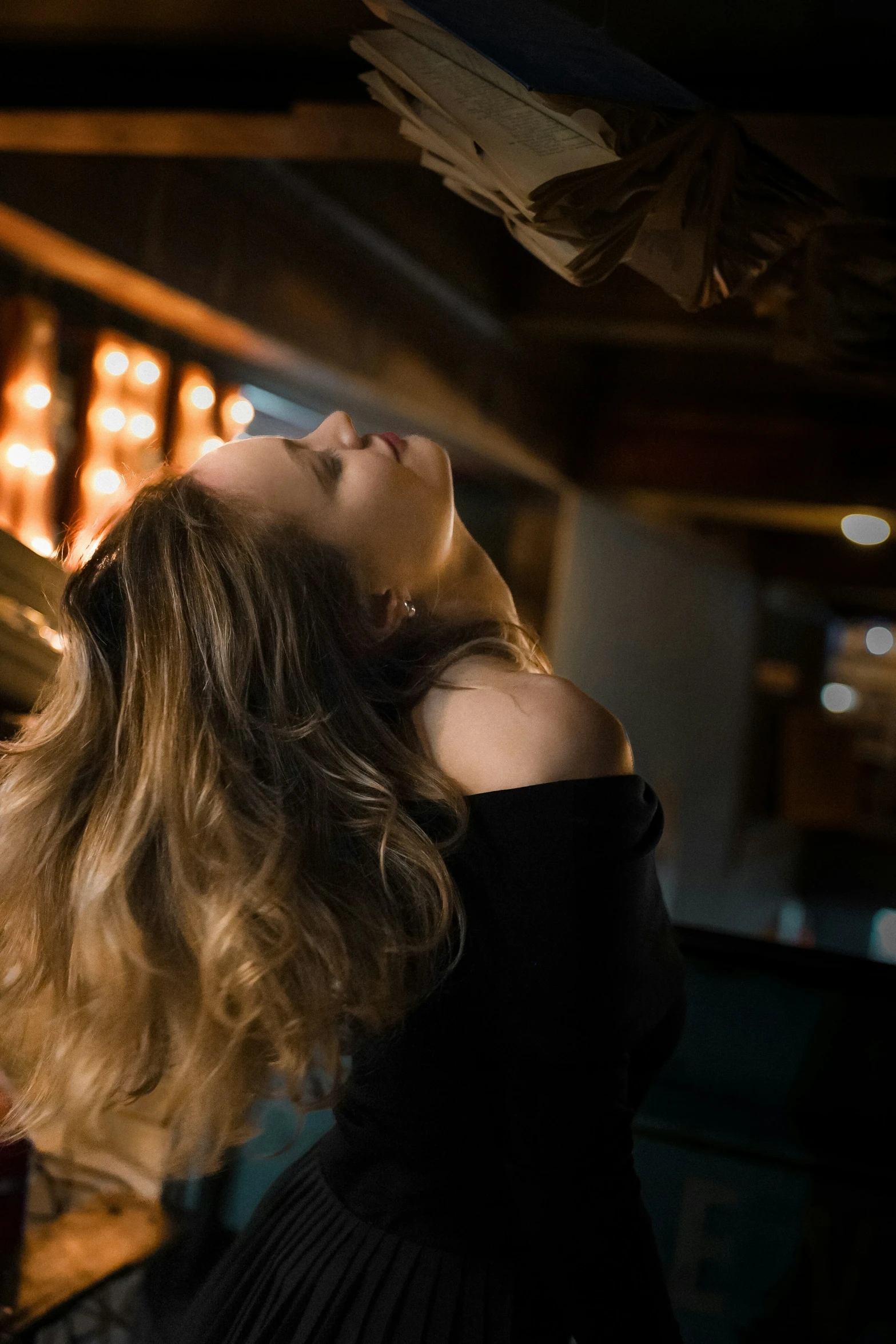 a woman with a very long hair posing in a dimly lit room