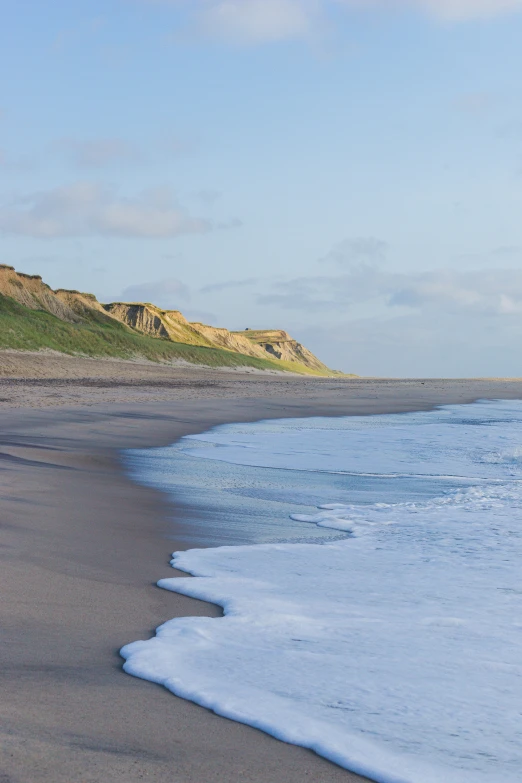 the water has washed over and is gently moving towards shore