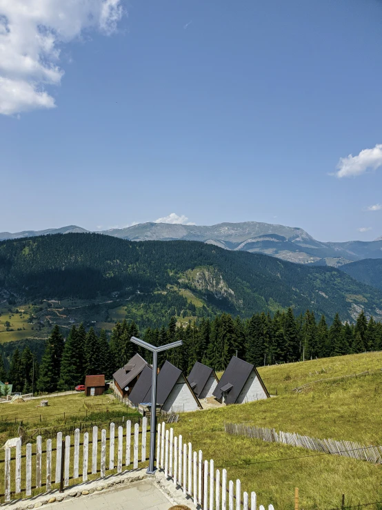 a view of mountains with houses in the foreground